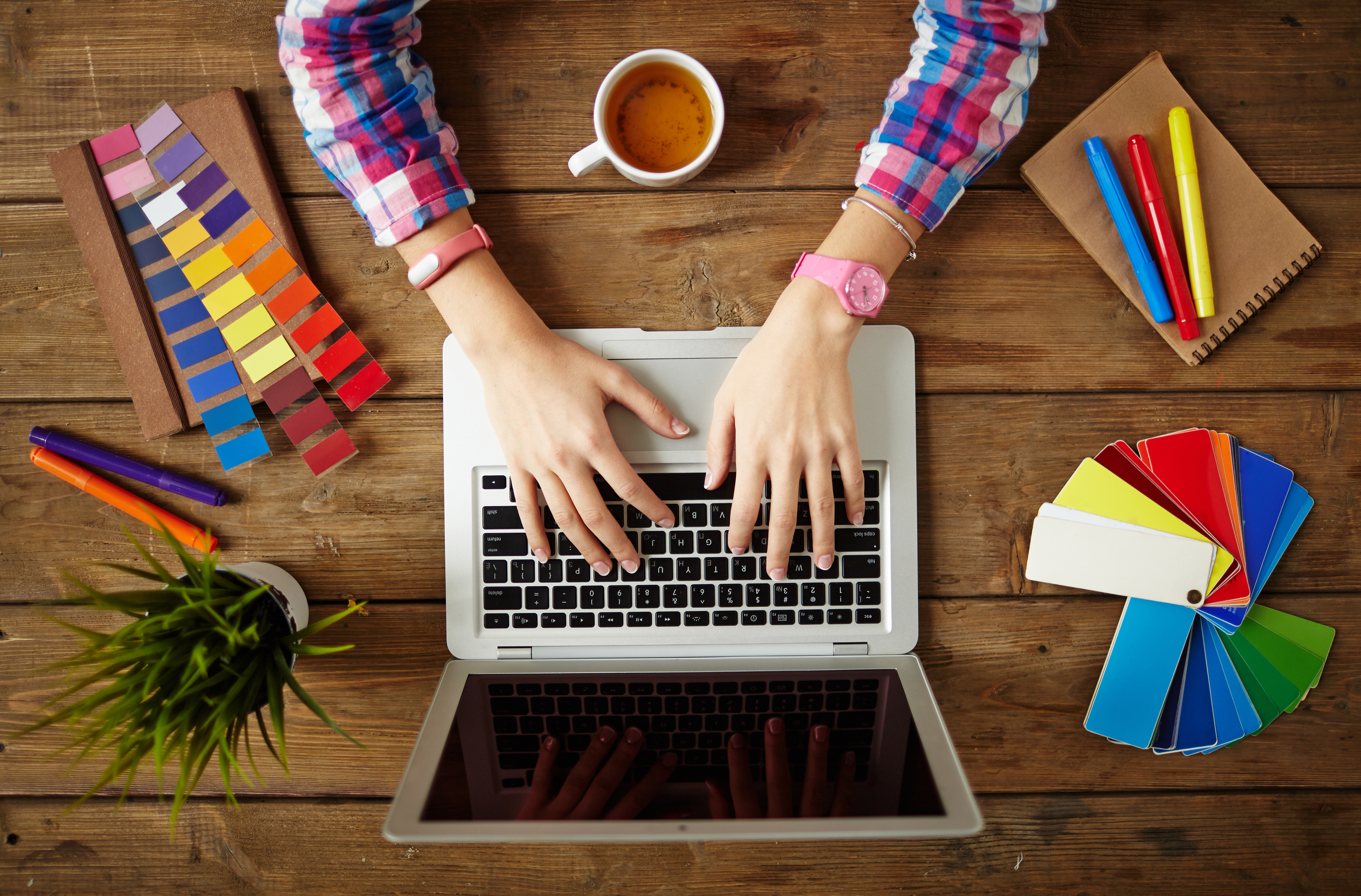 Person designing simple visual explainers on a laptop